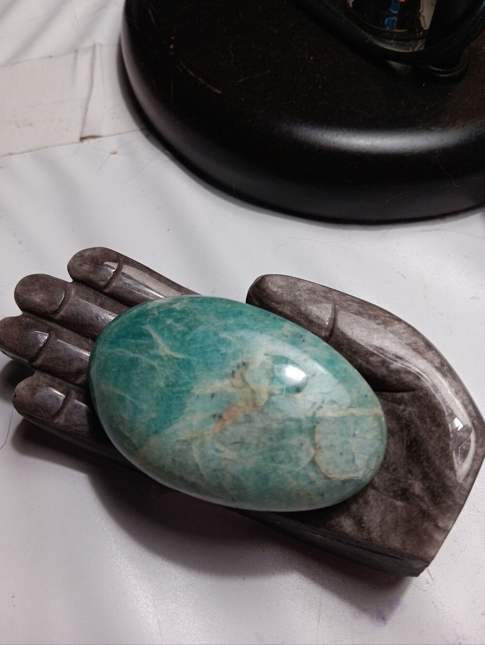 Amazonite Palm Stone On Silver Sheen Obsidian Hand